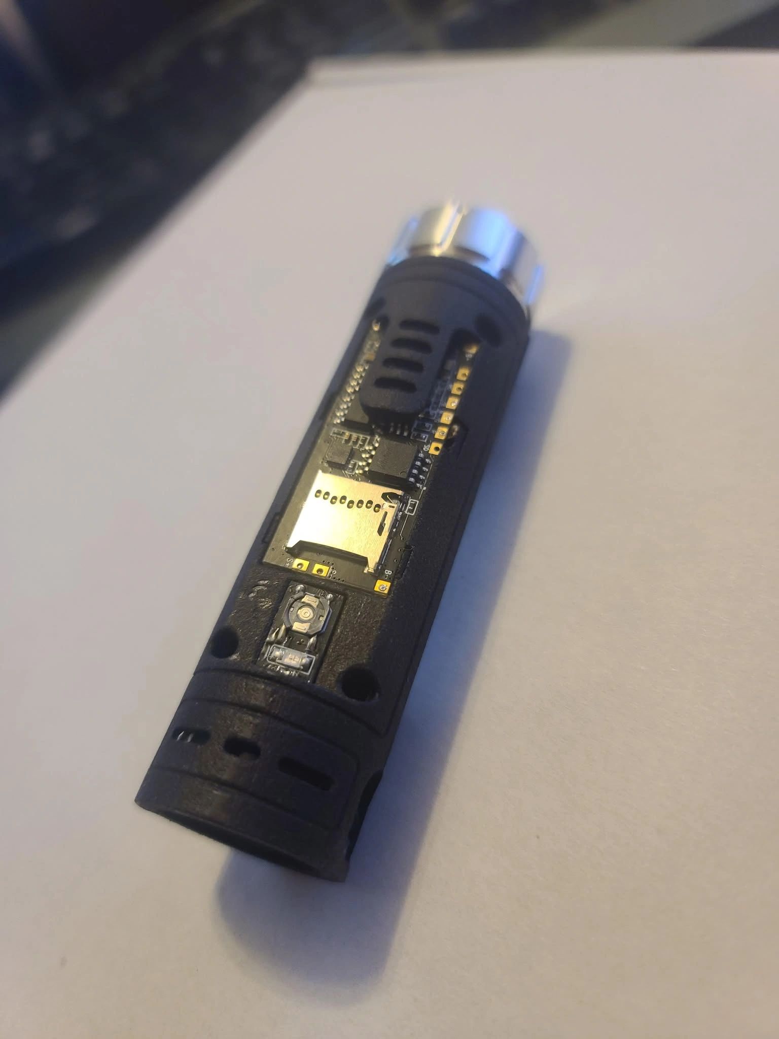 Close-up of a black USB device with a microSD card slot.