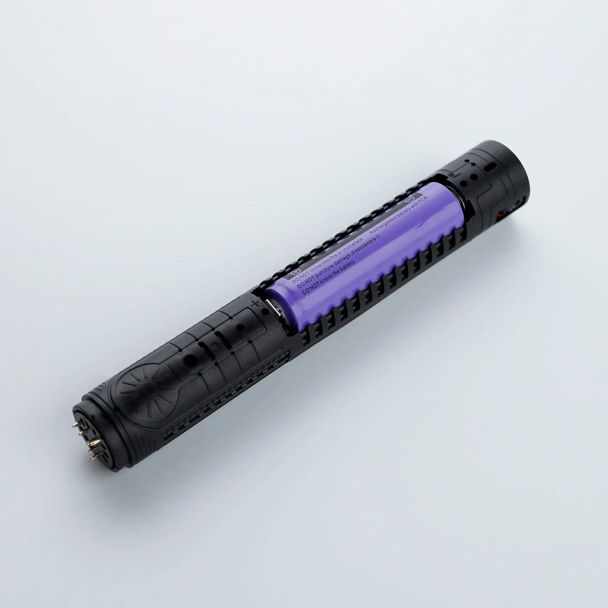 Black and purple flashlight with textured grip.