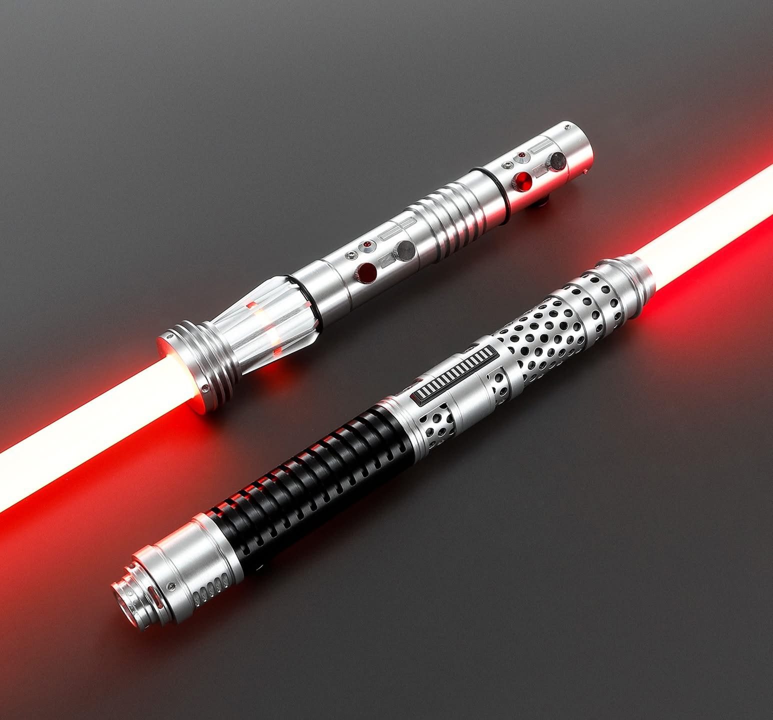 Two detailed lightsabers with red blades on a gray background.